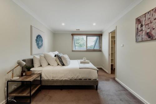 a bedroom with a bed and a couch in it at Modern apartment in the heart of Canberra in Kingston 