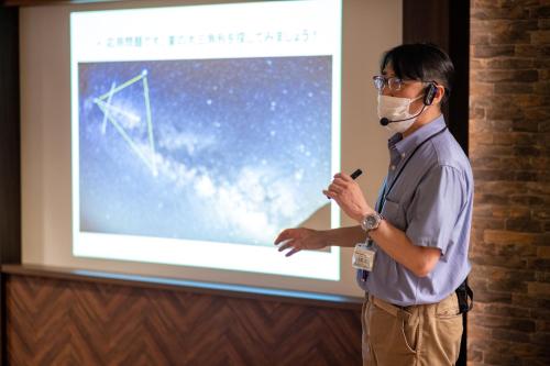 a man wearing a mask giving a presentation at Hachimantai Mountain Hotel & Spa in Hachimantai