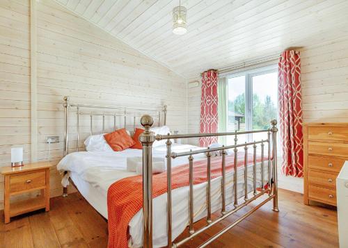 a bedroom with a bed and a window at Messingham Lakes in Messingham