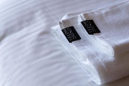 a close up of a white shirt on a bed at OND HOTEL（オンドホテル） in Takeo