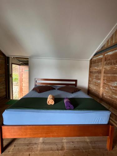 a person laying on a bed in a bedroom at Olala Bungalows and Restaurant in Sabong