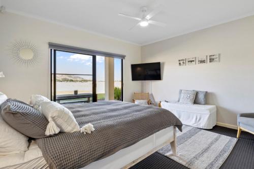 a bedroom with a large bed and a television at 3 61 St Andrews Boulevard in Normanville