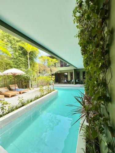 a swimming pool in a house at The Lodge Canggu in Tumbak Bayuh