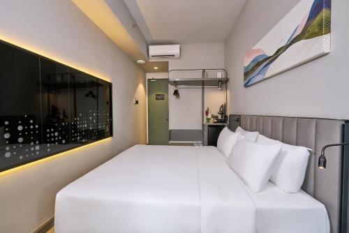 a bedroom with a large white bed in a room at Sleeping Lion Suites in Kuala Lumpur
