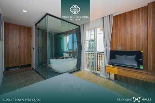 a bathroom with a tub and a sink and a television at Merci Hotels - Sunset Town Phu Quoc in Phú Quốc