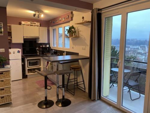 a kitchen with a counter and a view of the city at Appartement Aix-les-Bains, 2 pièces, 2 personnes - FR-1-617-82 in Aix-les-Bains