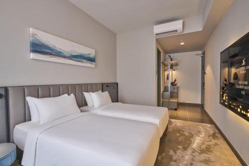 a bedroom with a large white bed in a room at Sleeping Lion Suites in Kuala Lumpur