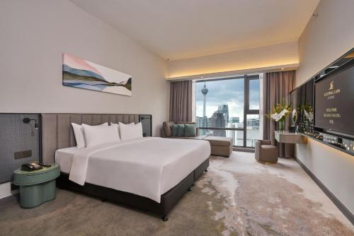 a hotel room with a large bed and a large window at Sleeping Lion Suites in Kuala Lumpur