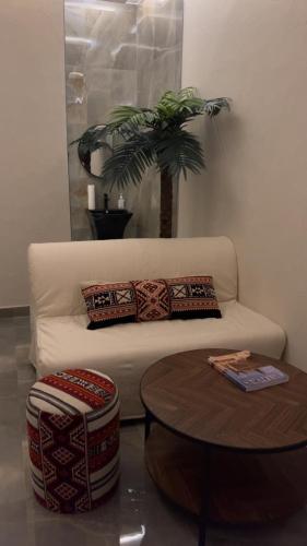 a living room with a white couch and a table at شقه بطراز نجدي فاخر 2 in Riyadh
