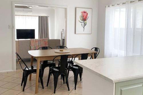 a dining room and kitchen with a table and chairs at Family home central to everything in Mildura