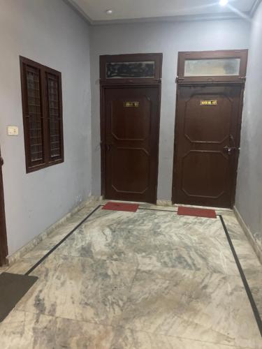 two doors in a room with a concrete floor at Star inn hotel in Meerut
