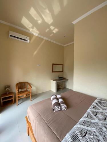 a bedroom with a bed with two pillows on it at Sumbul View Surfcamp in Airsatang
