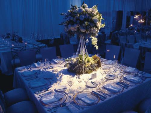 a table with a vase of flowers on it at Riu Plaza Guadalajara in Guadalajara