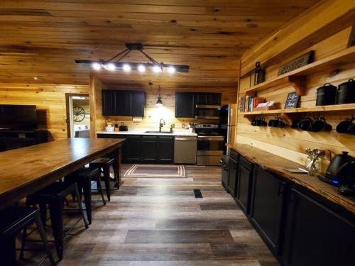 a large kitchen with a long wooden counter top at Luxury Cabin w/ Game Room & Hot Tub at Cave Run Lake in Wellington