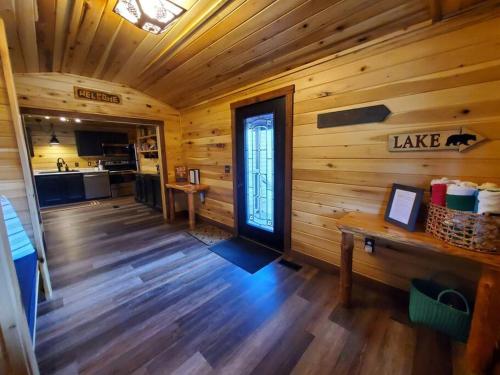 a cabin with a wooden floor and a door at Luxury Cabin w/ Game Room & Hot Tub at Cave Run Lake in Wellington