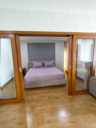 a bedroom with a large bed with two purple pillows at View Talay6 by Blue Ocean Suite in Pattaya Central
