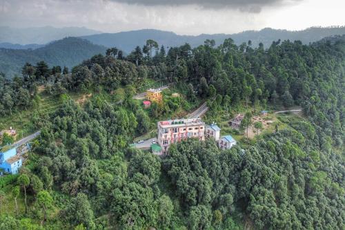 an aerial view of a house in the middle of a forest at Binsar Eco Resort, Binsar - Uttarakhand in Hawālbāgh
