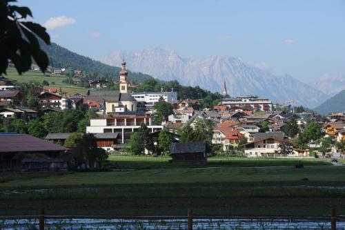a small town with a mountain in the background at Pension Margretenhof in Fulpmes