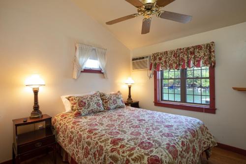 a bedroom with a bed and a ceiling fan at Sunset Cottage #3 in Hamilton