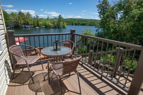 a balcony with a table and chairs and a view of the water at Sunset Cottage #3 in Hamilton