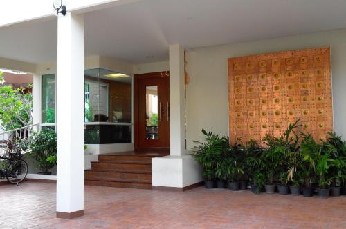a front door of a house with plants at U Tiny Boutique Hotel Suvarnabhumi Bangkok - SHA Plus in Lat Krabang