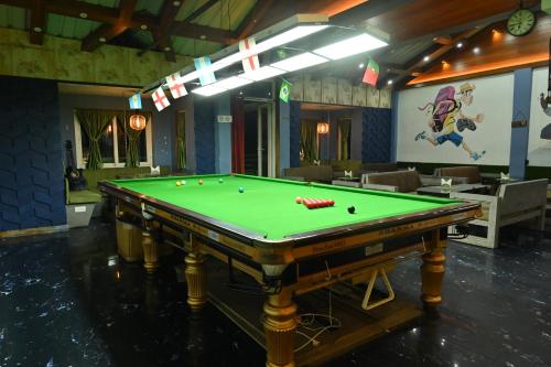 a pool table with balls on it in a room at Zingo's Home Stay in Darjeeling