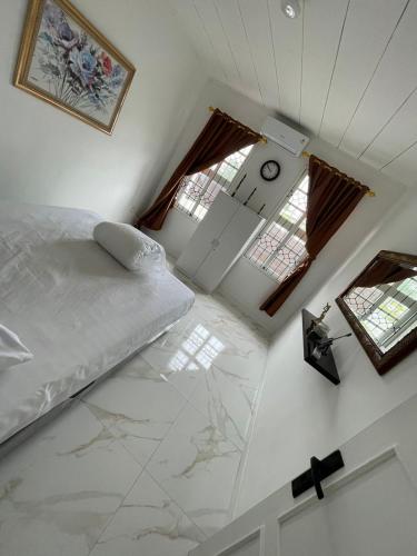 a bedroom with a bed and a clock on the wall at Villa Omar in Cikujang