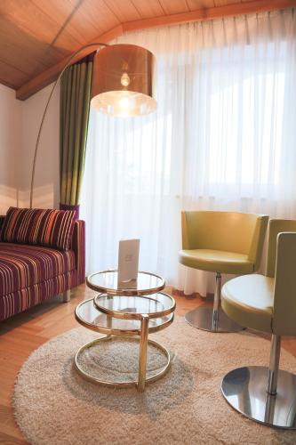 a living room with a couch and a table with a laptop at WOHNEN by LIZZY in Wagrain