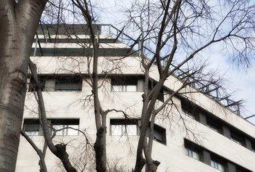 a white building with trees in front of it at Hotel Sant Pau in Barcelona