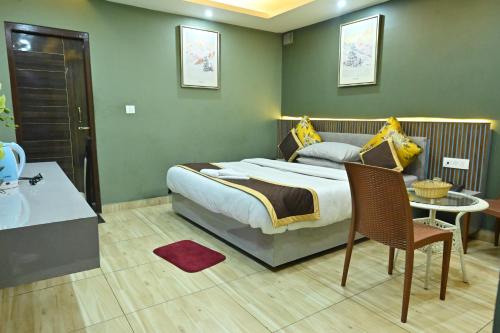 a bedroom with a large bed and a table at Zingo's Home Stay in Darjeeling