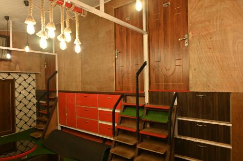 a room with wooden cabinets and a staircase with green seats at Zingo's Home Stay in Darjeeling