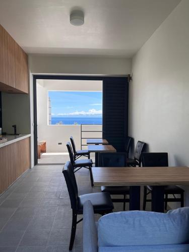 a dining room with a table and chairs and a view at Dawn Valley in Green Island