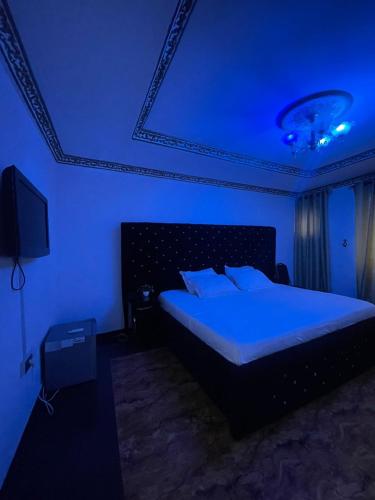 a bedroom with a bed in a blue room at Ikorodu Guest House in Lagos