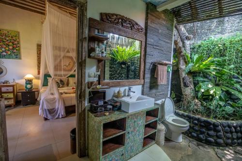 a bathroom with a sink and a toilet at KTS Balinese Villas in Canggu