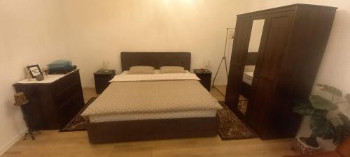 a bedroom with two beds and a dresser and a mirror at LUNA in Oradea