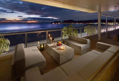 a balcony with couches and a view of the ocean at THE VIEW KAMAKURA in Kamakura