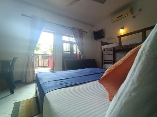 a bedroom with a bed and a window at Andorra Tourist Resort Anuradhapura in Anuradhapura