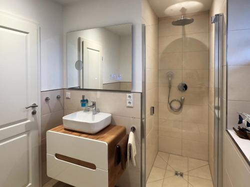 a bathroom with a sink and a shower at Dünenperle Dünental in Wittdün