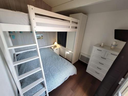 a bedroom with a bunk bed and a ladder at Front de mer, vue à 180° sur la méditerranée, accès direct plage in Cap d'Agde