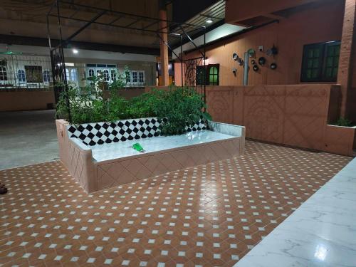 a large room with a bath tub in a building at At Night in Chumphon