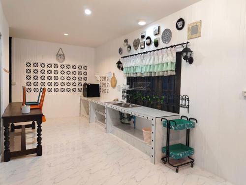 a kitchen with a sink and a counter in a room at At Night in Chumphon