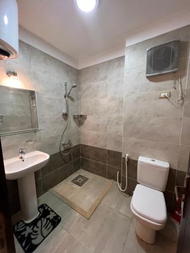 a bathroom with a toilet and a sink and a shower at KUBA LuXuS - VillA in Sahl hashesh-hurghada in Hurghada