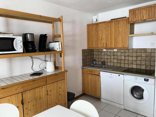 une cuisine avec un lave-linge et un micro-ondes dans l'établissement Residence Tigny - 2 pièces cabine 4 personnes exposé sud est MAE-9034, à Valloire