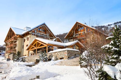 a house covered in snow in front of it at Chalets Du Galibier I - 2 Pièces pour 4 Personnes 74 in Valloire