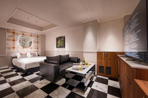 a hotel room with a bed and a couch at コスタリゾート茅ヶ崎大人専用 in Suka