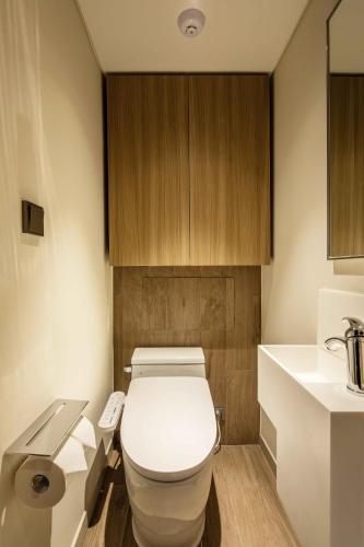 a bathroom with a white toilet and a sink at Sotetsu Fresa Inn Seoul Myeong-dong in Seoul