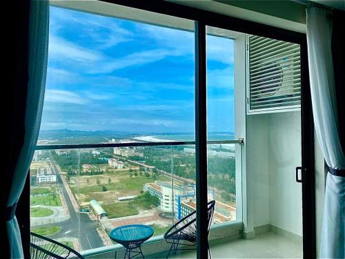 a large window with a view of a city at Luna Apartment - Apec Mandala Phú Yên in Tuy Hoa