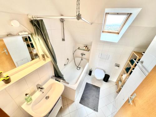 a small bathroom with a sink and a toilet at Modernes Apartment mit Blick zur Elbe in Klipphausen