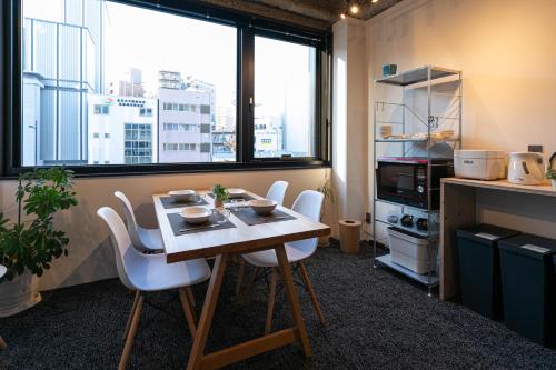 a kitchen with a table and chairs in a room at City Center Villas ゲストハウス35 supported by COCOSTAY in Hijiyamachō