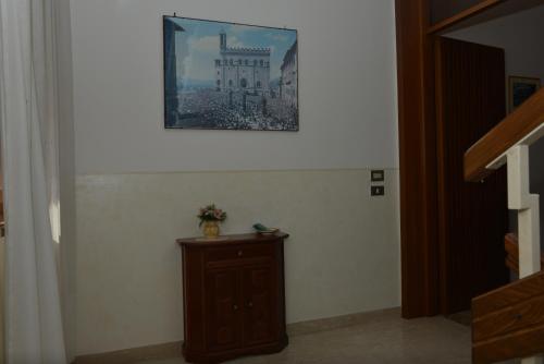 a room with a picture on the wall and a table at Hotel Santa Maria in Assisi